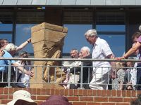 Tony Benn examining the statue
